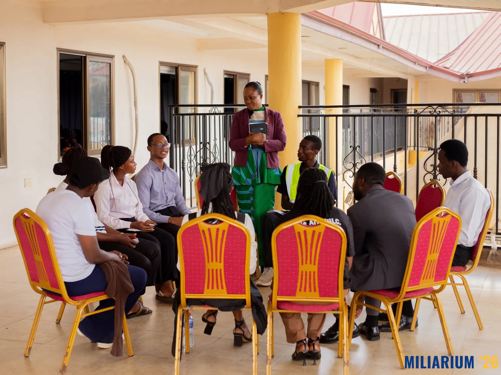 A circle of participants in conversation on the terrace of the Centre